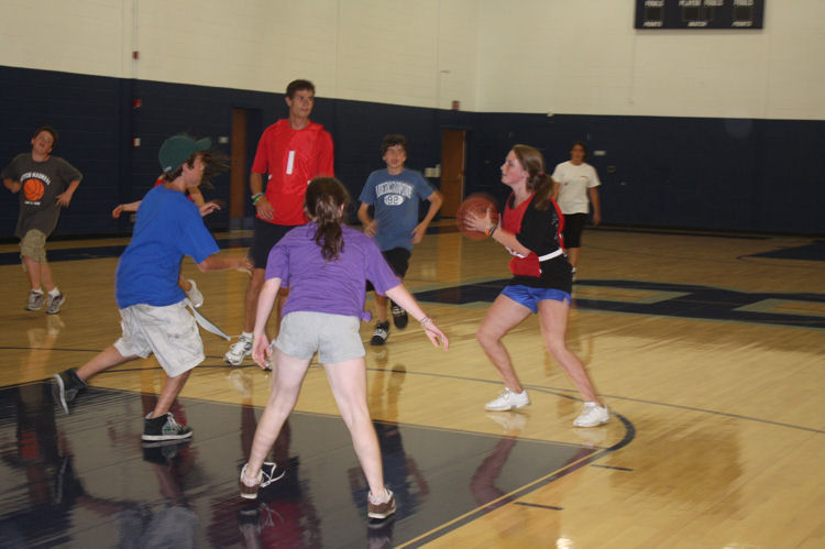 Boy and girls playing basketball