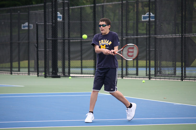 boy playing tennis