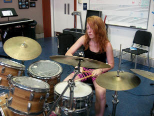 Gril playing drums